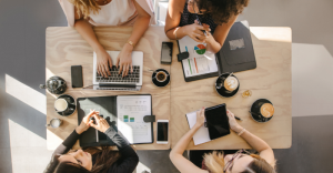 overhead photo of four women working at a coffee shop 