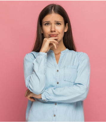 Woman in blue button up with a thinking face with a pink background